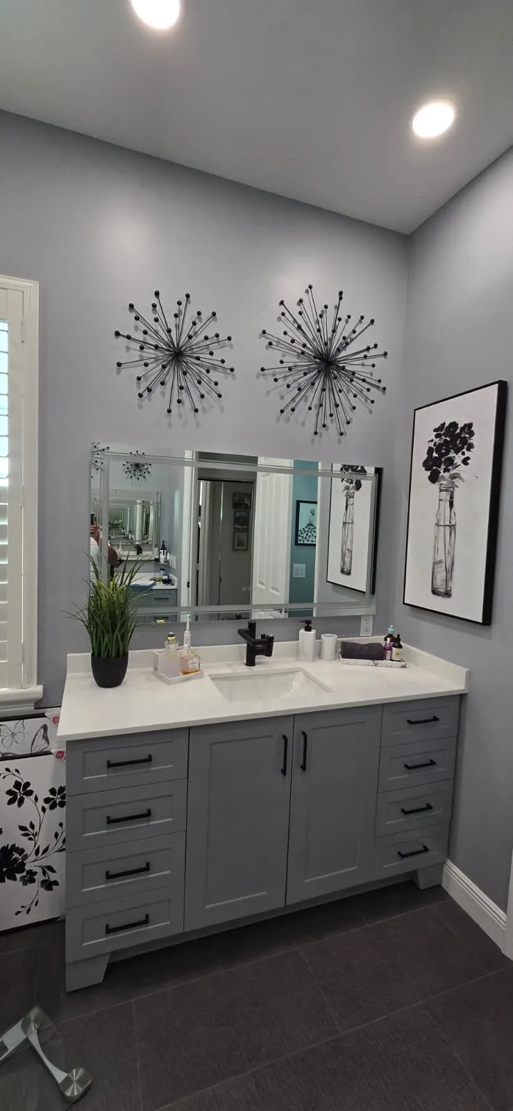 Blue-gray shaker vanity with white quartz top and black faucet